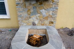 Firepit with quartzite wall and granite cross