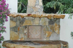 Outdoor fireplace with cypress mantle