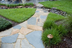 Stone path with boulder step in dry-creek bed
