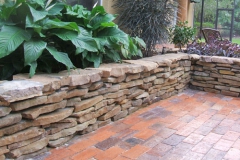 Stacked stone raised planter bed