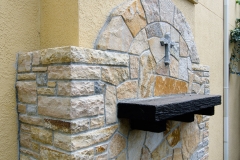 Quartzite wall with granite cross, side view